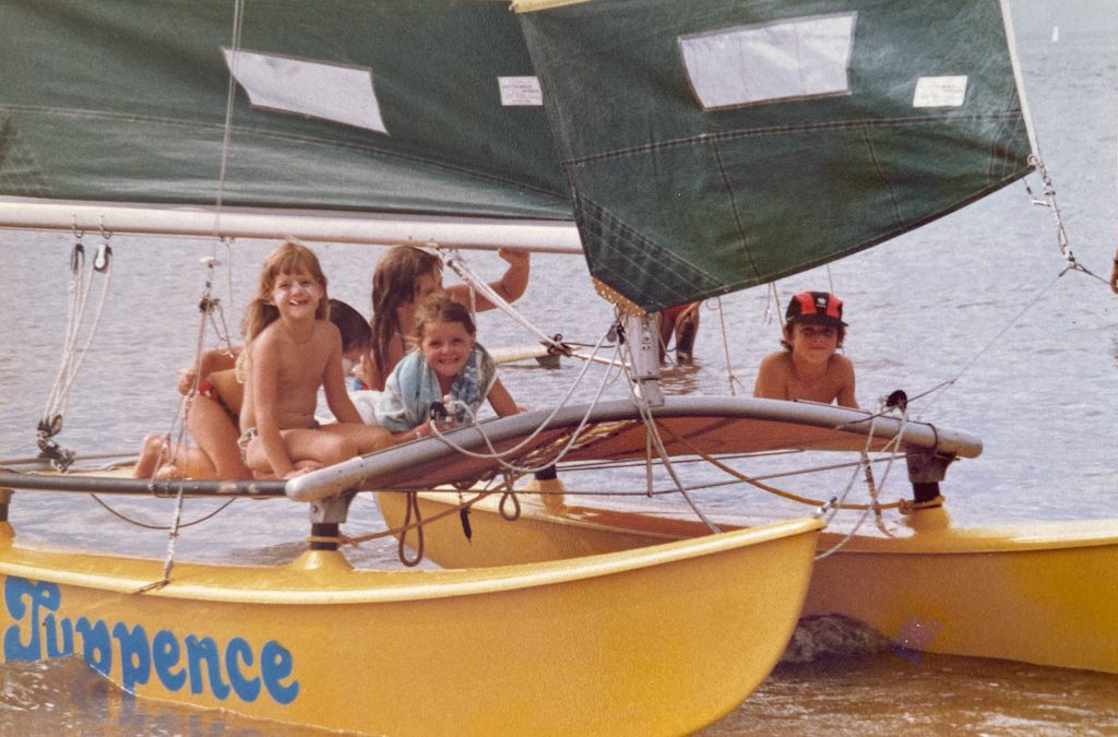Yellow Hobie 16 catamaran with 10-year-old Shaun McKenna on the right, his sister, and friends sitting on the boat.