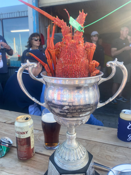 The Grassy Perpetual Trophy with a King Island crayfish at the 2 The Grassy Perpetual Trophy with a King Island crayfish at the 2025 ORCV Melbourne to King Island Race presentation, King Island Boat Club, Grassy Harbour, Tasmania