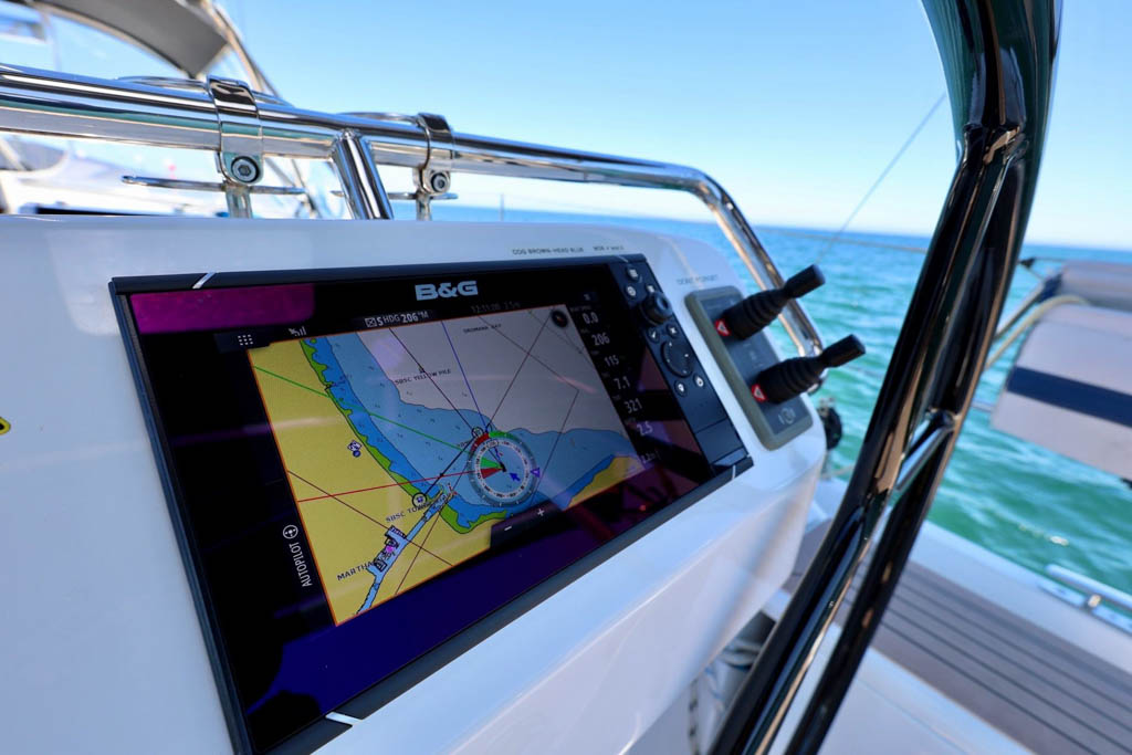 B&G Navigation System on Hanse 458 Close-up view of the dual B&G marine navigation system plotters and Triton displays mounted in custom fiberglass helm pods at the steering station of a Hanse 458 yacht.