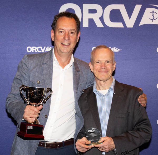 Coastal Champions Cam McKenzie and Nigel Jones of Ginan standing together at the ORCV media wall, holding their trophies.