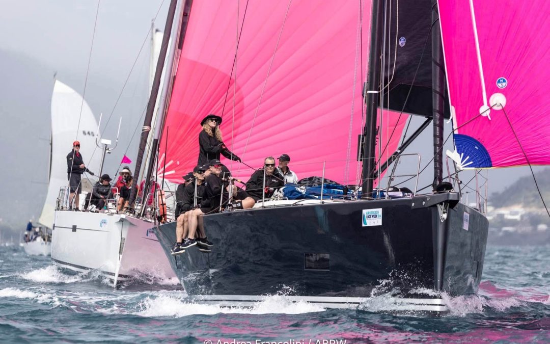 Solaris 50 yacht Salt flying a pink spinnaker on Pioneer Bay at Airlie Beach Race Week 2026.