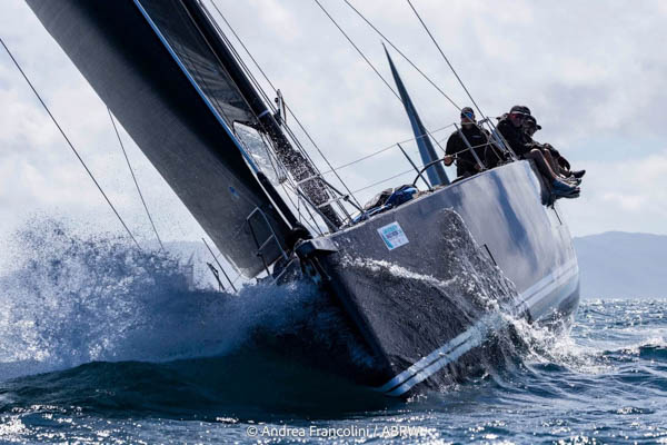 Solaris 50 Salt – Action Shot on the Rail at Airlie Beach Race Week Front angle of Solaris 50 yacht Salt heeling with crew on the rail and water spraying off the bow during Airlie Beach Race Week.