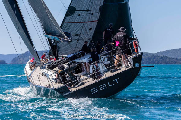 Solaris 50 Salt Transom – Close Racing Action Rear view of Solaris 50 yacht Salt showing transom name as it sails away, with competing yacht crossing ahead.