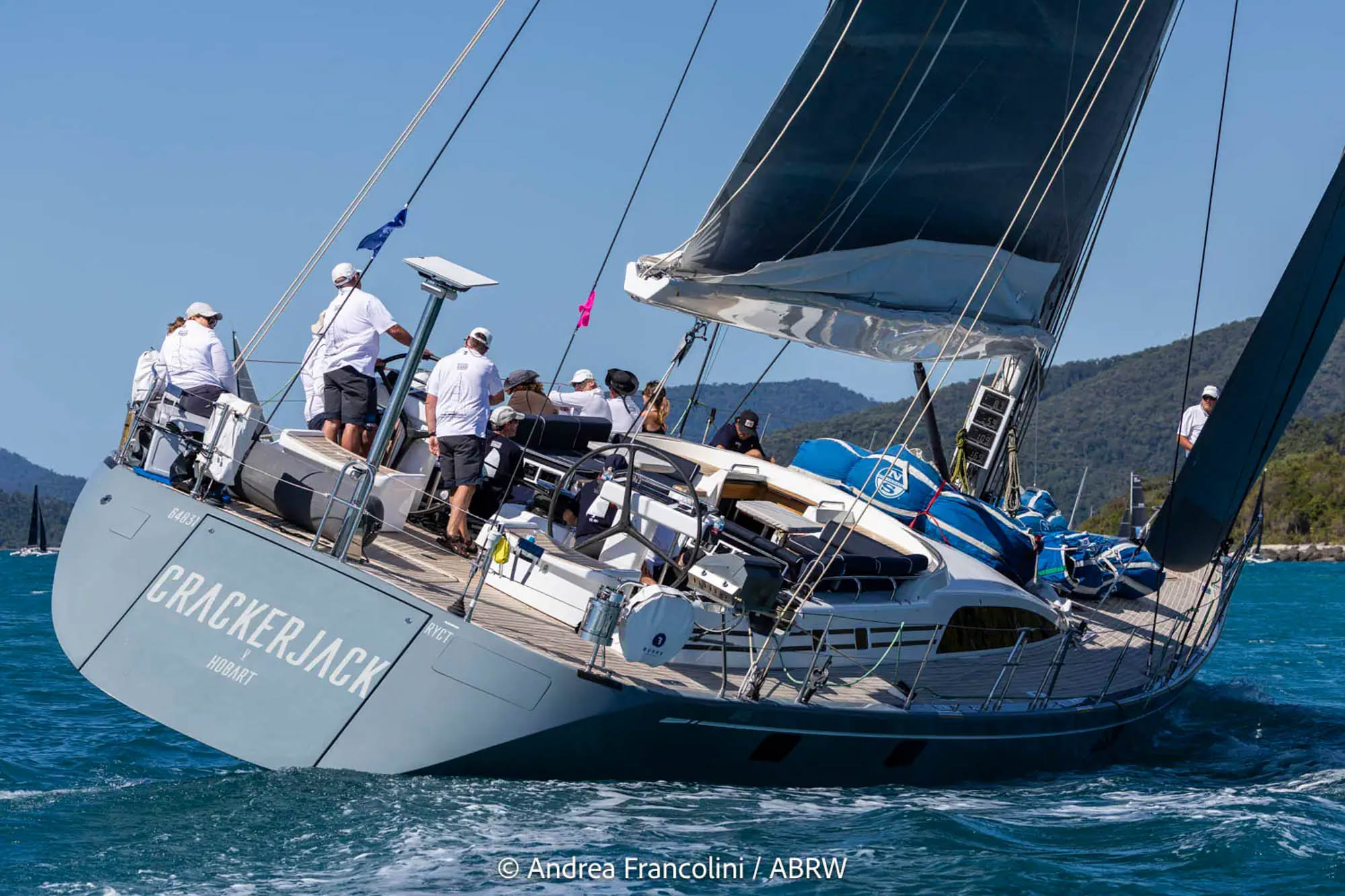 Water-level view of Swan 82 yacht Crackerjack V showing her stern and starboard side while racing at Airlie Beach Race Week 2026.