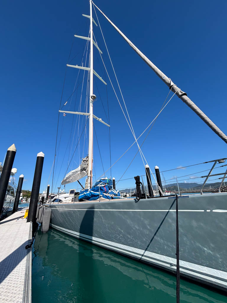 Swan 82 Crackerjack V – Dockside Low Angle Mast View Wide low-angle shot from the dock looking up at the hull and massive mast of Swan 82 yacht Crackerjack V.